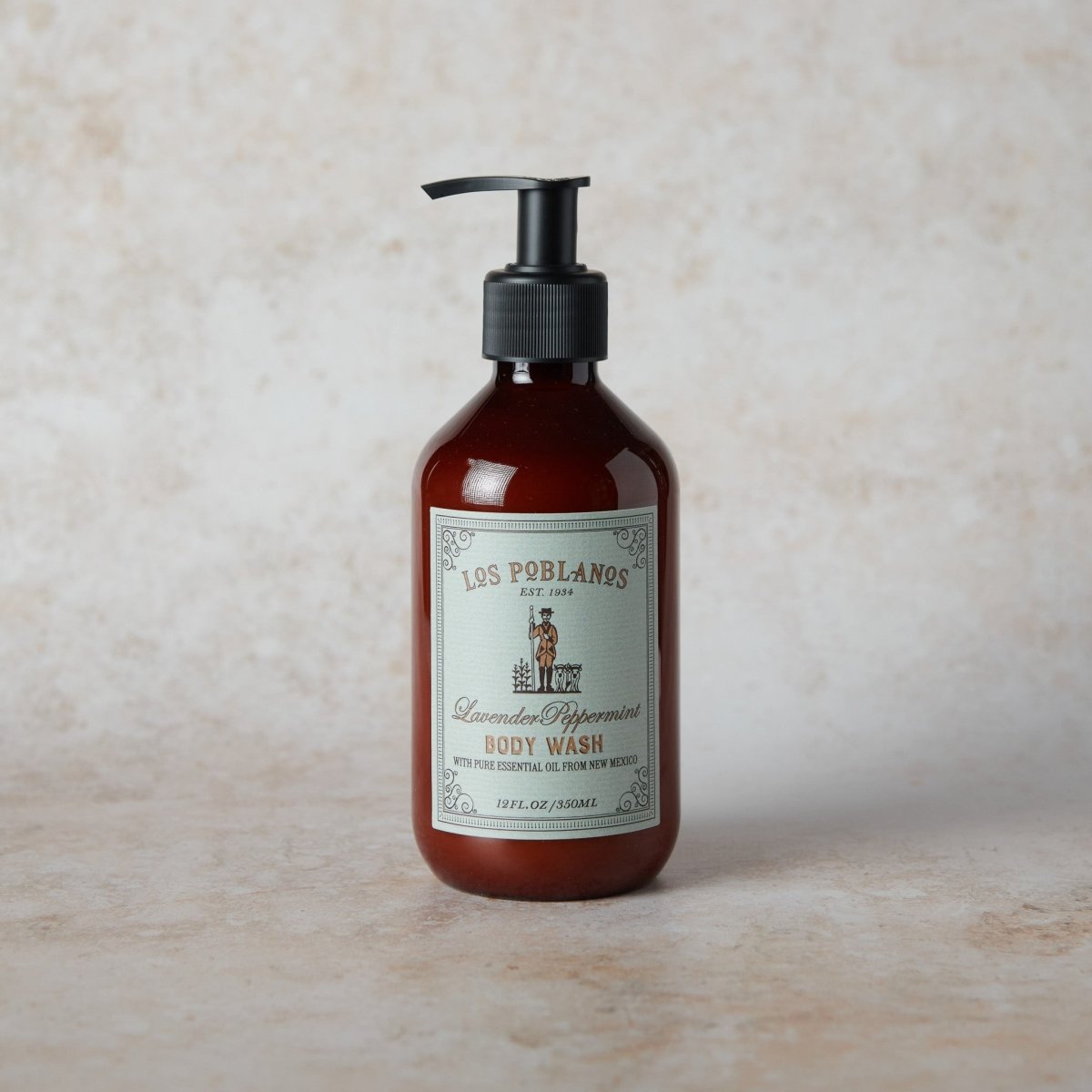 Bottle of Los Poblanos Lavender Peppermint Body Wash on a beige background