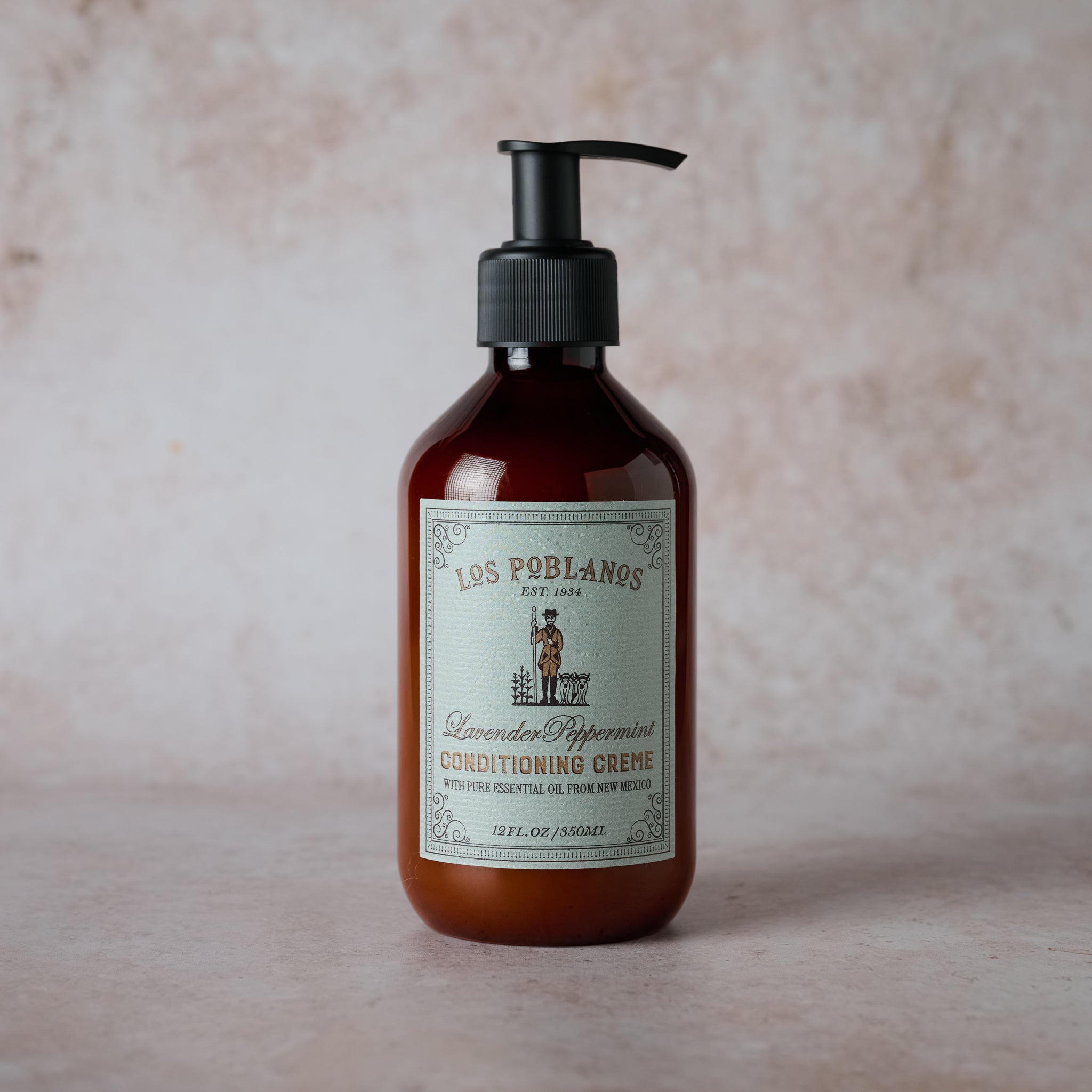 A pump bottle of Los Poblanos Lavender Peppermint Conditioning Crème with a label featuring the brand name and product description.