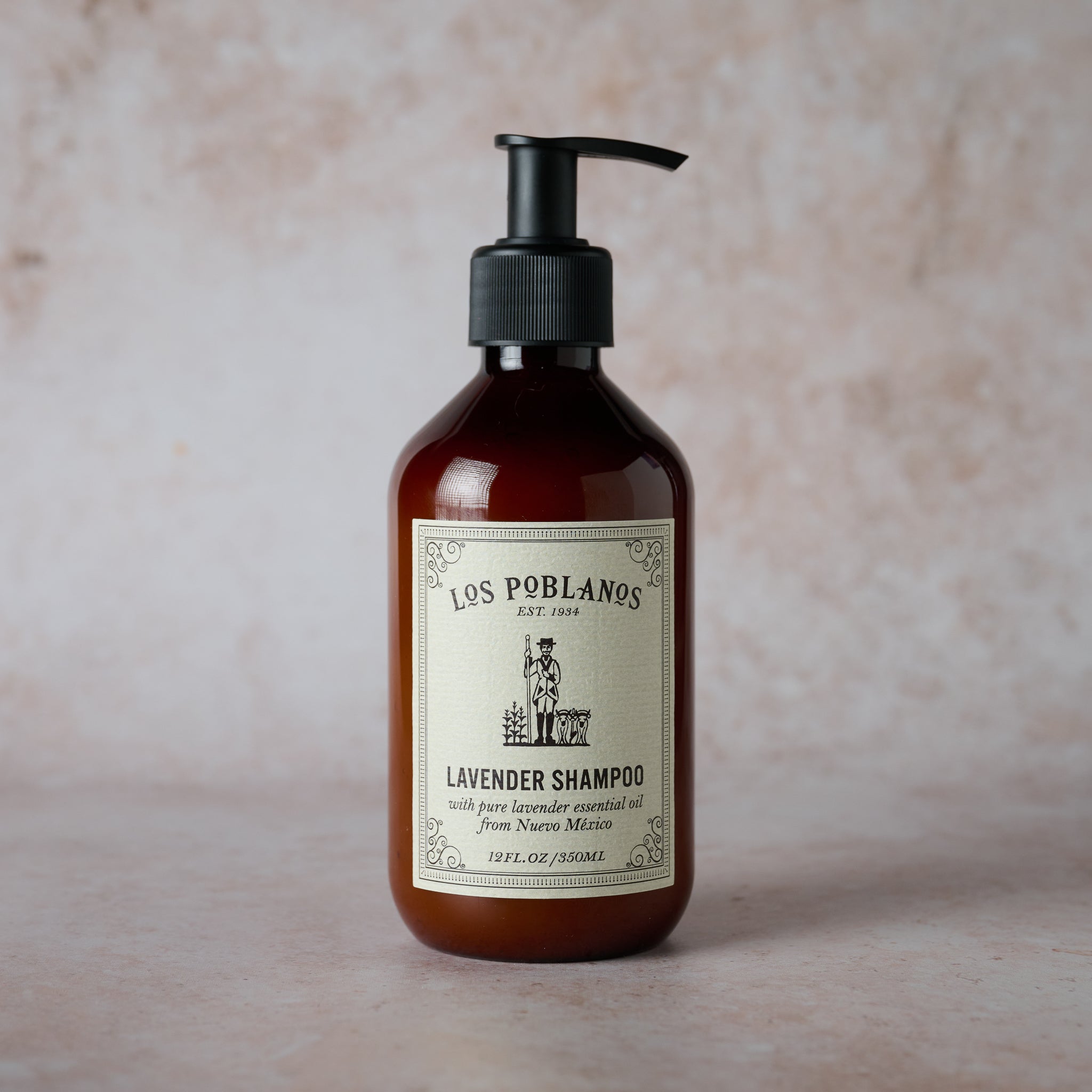 A pump bottle of Los Poblanos Lavender Shampoo with a label that includes the brand name and the words 'Lavender Shampoo with organic lavender essential oil from New Mexico'.