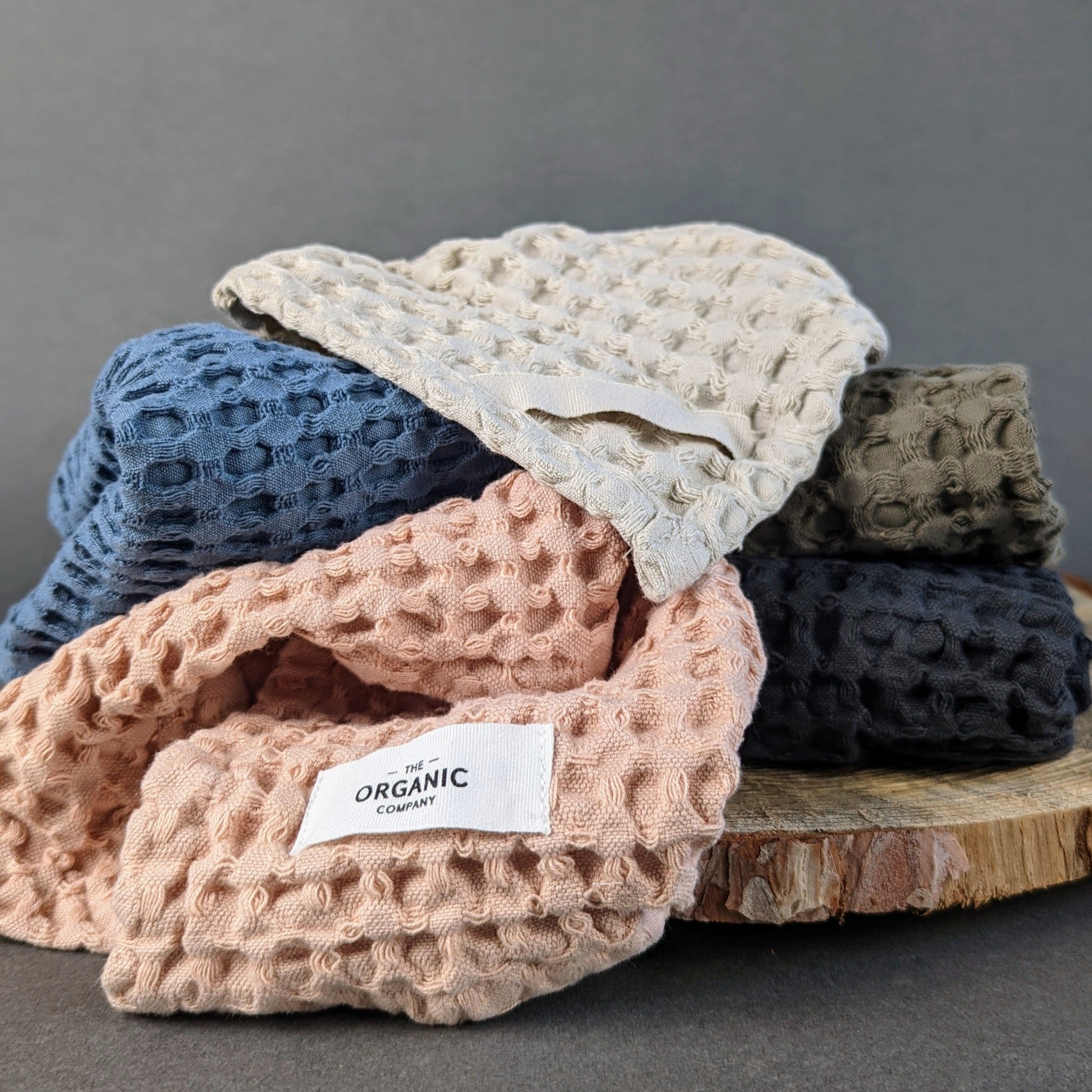 Minimalist set of three waffle-textured wash cloths made in India from organic cotton, each with a hanging loop—ideal for personal care or guest towels.