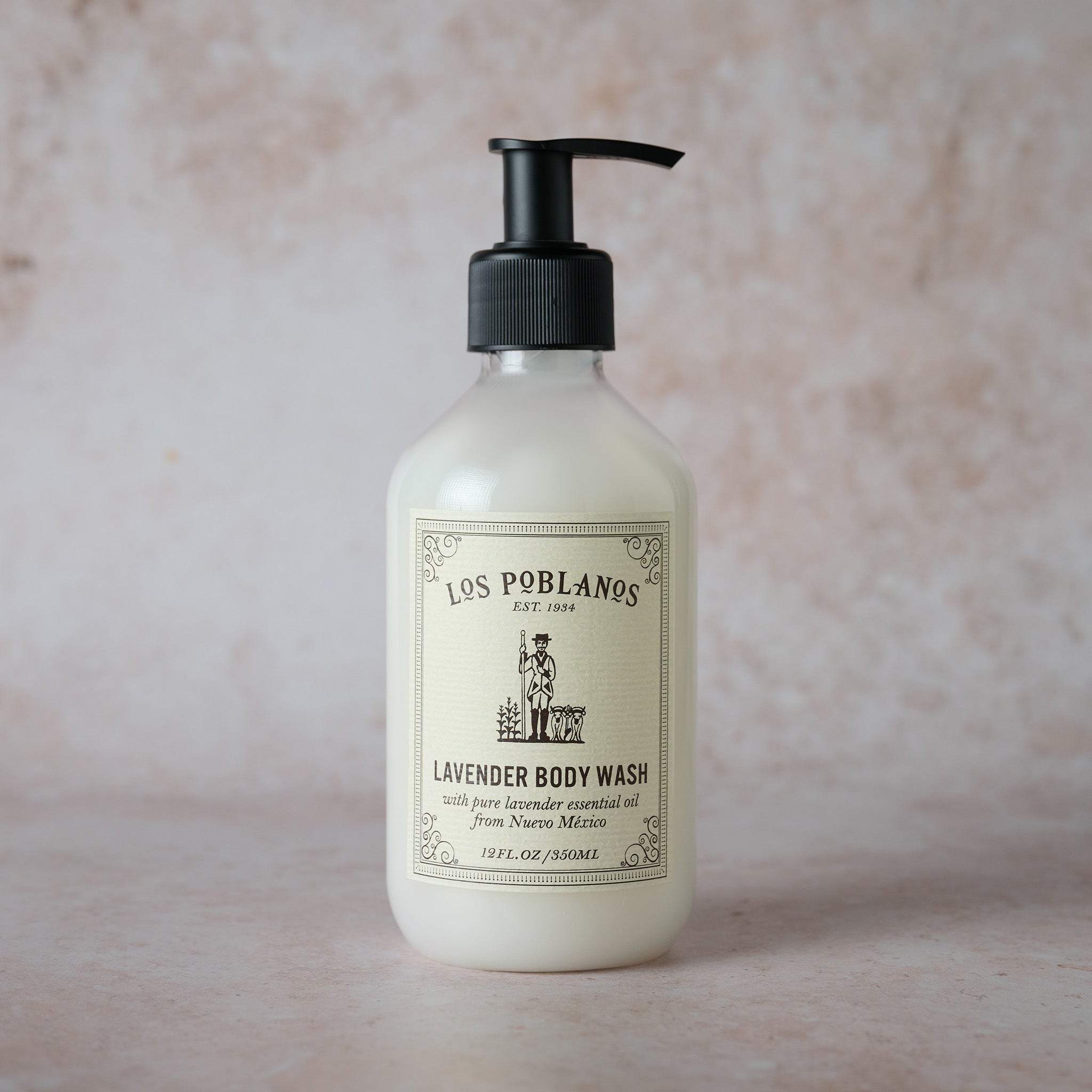 Los Poblanos lavender body wash bottle on a textured beige background