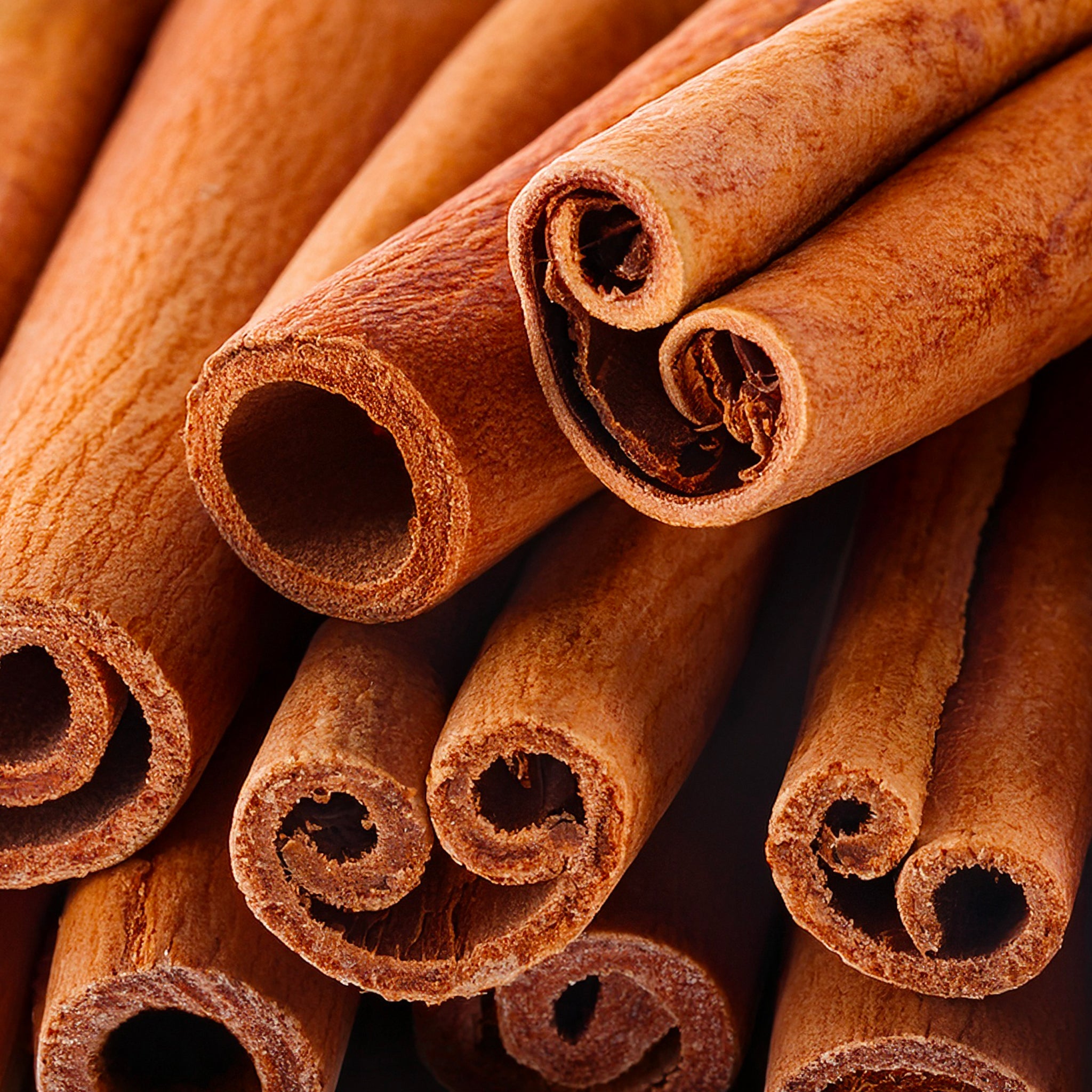 Close-up of cinnamon sticks with a warm brown color.