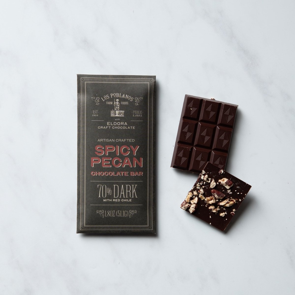 Spicy Pecan chocolate bar with packaging on a light gray background