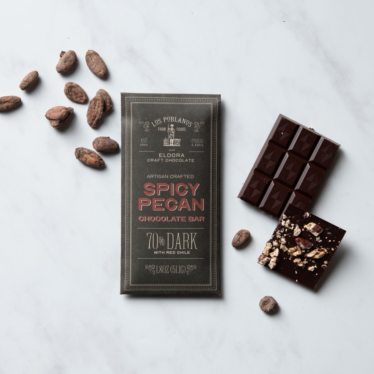 Spicy Pecan chocolate bar with packaging on a light gray background