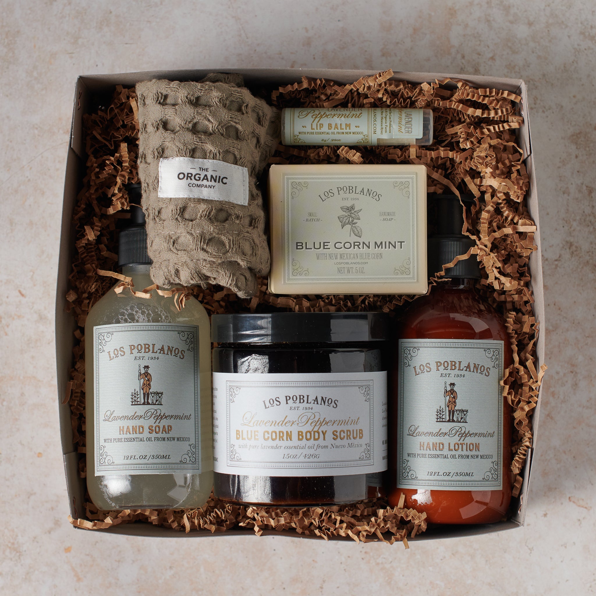 Gift set with various skincare products in a box on a neutral background