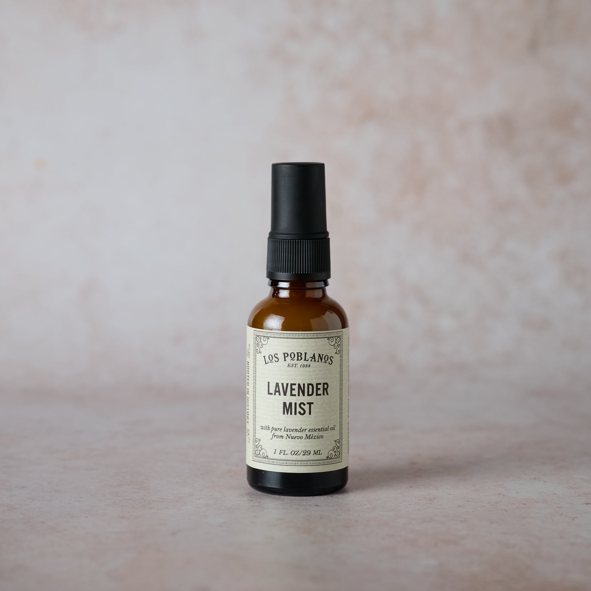 A spray bottle labeled 'Lavender Mist' on a neutral background, indicating it is a lavender-scented body or room spray.