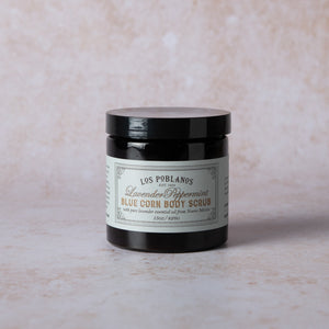 Jar of Lavender Peppermint Blue Corn body scrub with white product label, raw sugar/salt texture and hints of blue corn—luxury spa exfoliant by Los Poblanos.