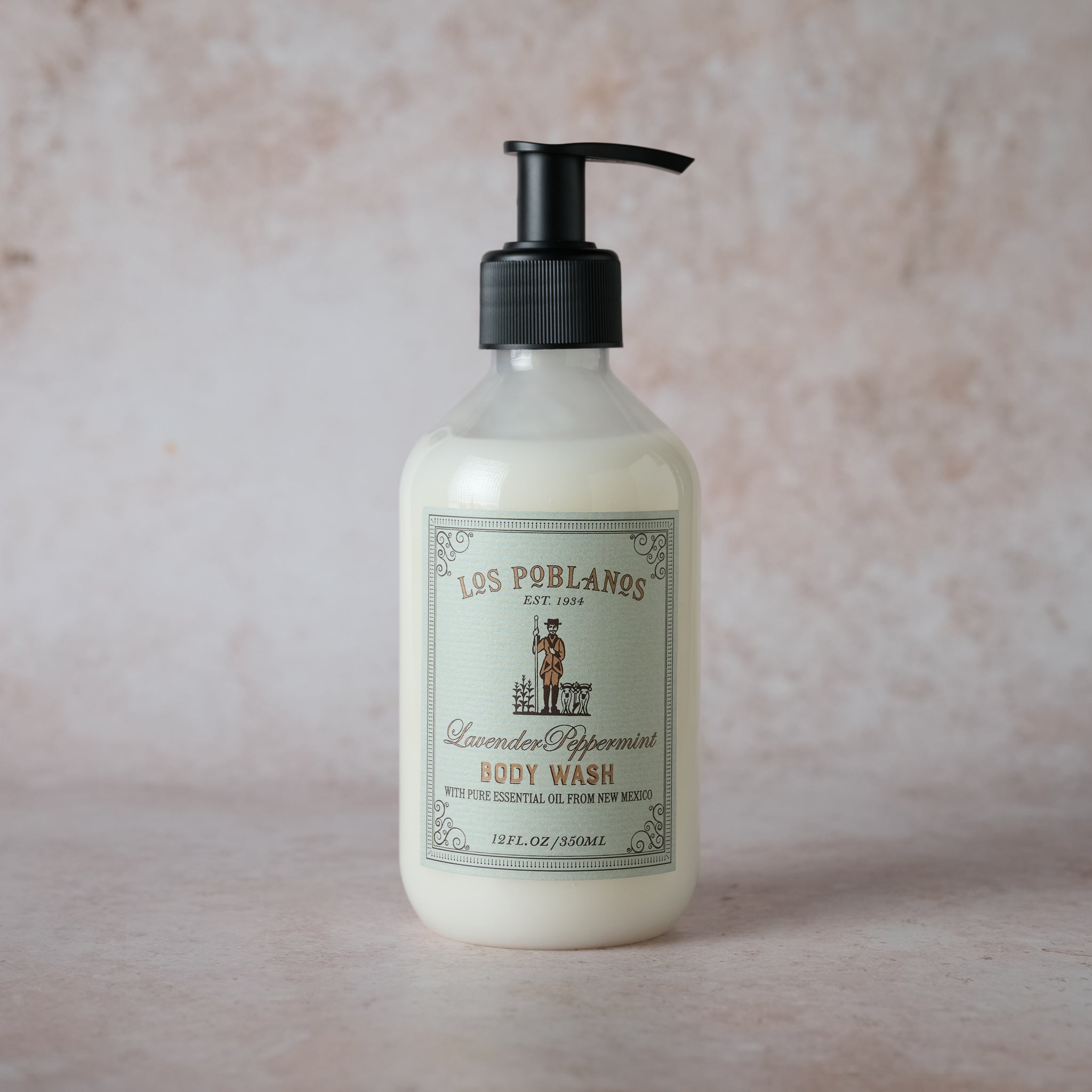 Lavender Peppermint Body Wash: white bottle with silver pump, featuring the Los Poblanos logo and text highlighting certified organic Grosso lavender and peppermint oil