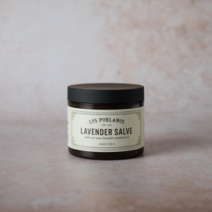 A 4 oz amber plastic jar of Los Poblanos Lavender Salve with a label that includes the product name and the fact that it is made with organic lavender.