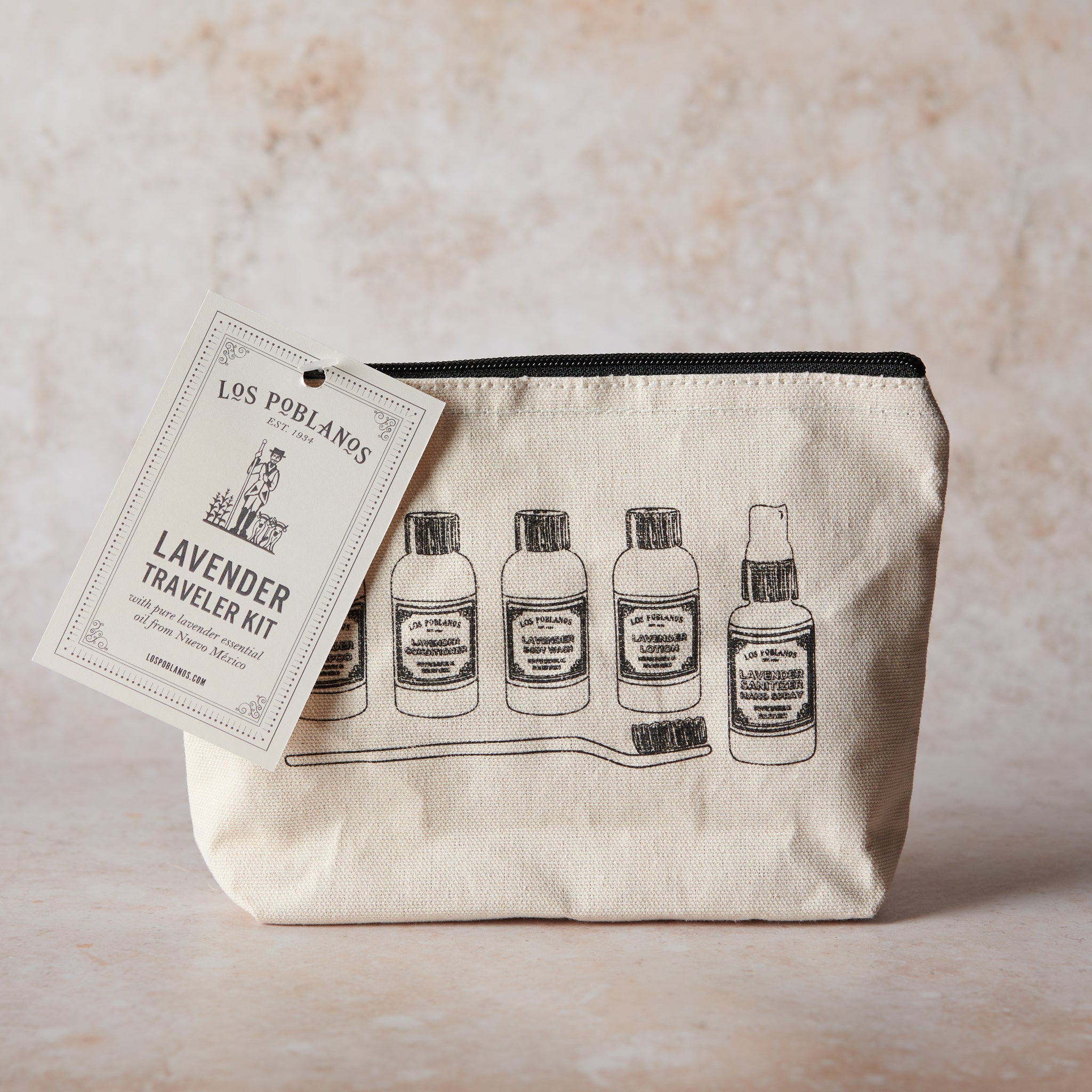 Traveler kit's beige cotton canvas pouch with printed text and illustrations.