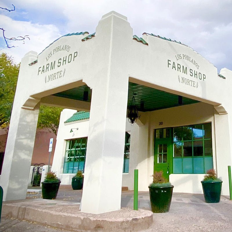 White building with 'Farm Shop Norte' sign under a blue sky
