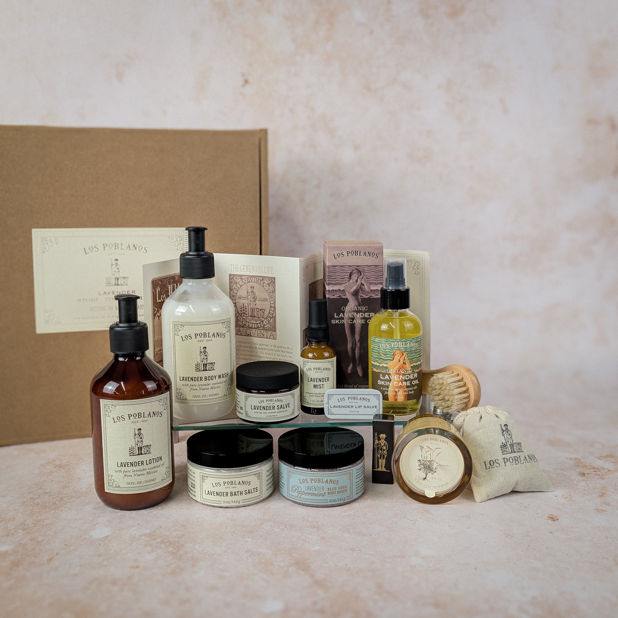 Collection of skincare and grooming products with branded packaging on a textured surface.